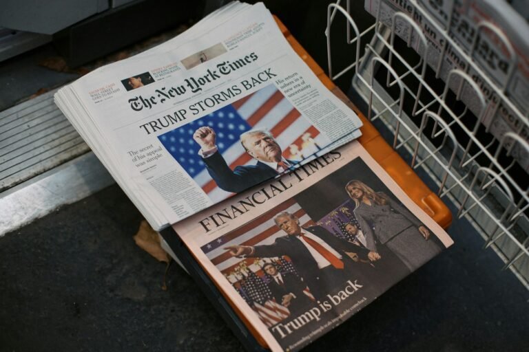 A newspaper sitting on top of a metal dishwasher