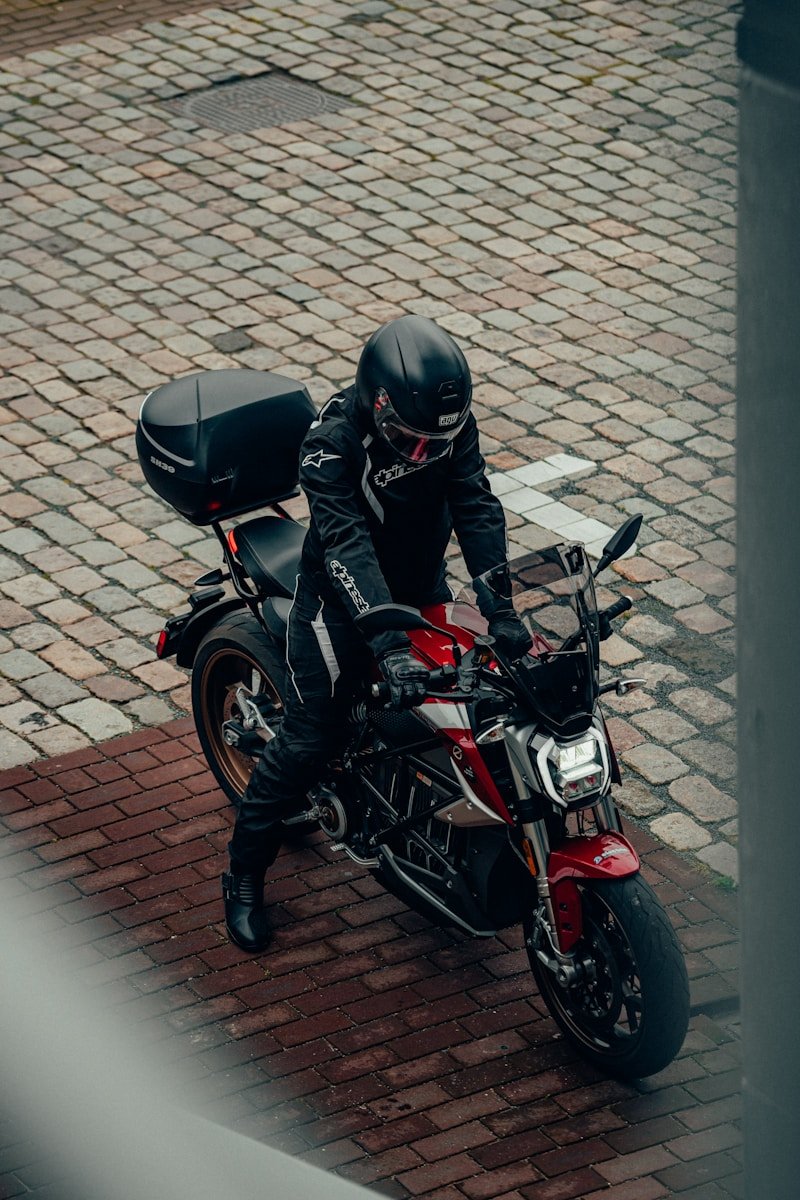 California Proposes Regulations to Boost Electric Motorcycle Sales Amid Concerns from Riders 1 man in black leather jacket and black helmet riding red and black motorcycle