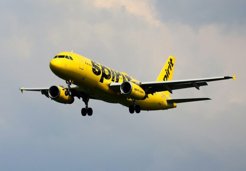 a yellow and black airplane flying