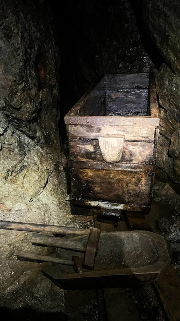 A wooden box sitting inside of a cave