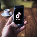 TikTok on iPhone in cafe