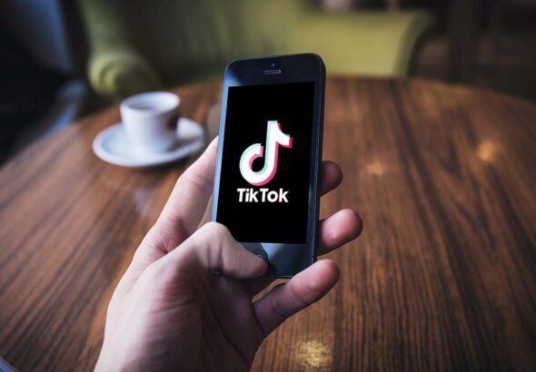 RIP TikTok: How America’s Favorite Scroll Came to a Sudden Stop 99 TikTok on iPhone in cafe