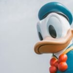 a large mickey mouse balloon with a bow tie, Disney, travel, kids, entertainment