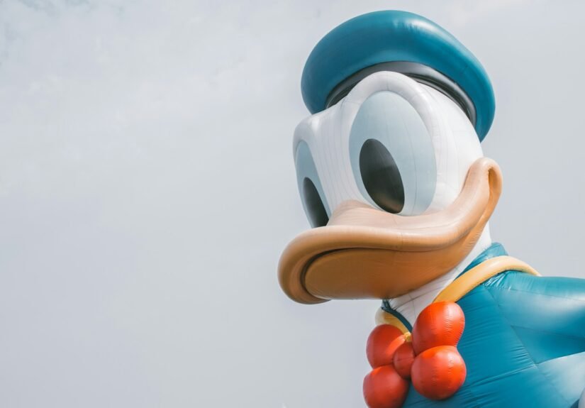 a large mickey mouse balloon with a bow tie