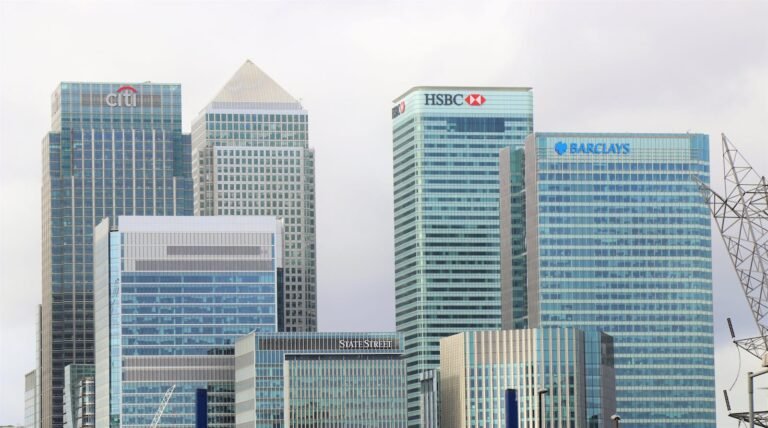 FinCEN Imposes $37 Million Penalty on Brink’s Global Services USA for Bank Secrecy Act Violations 2 Modern skyline of Canary Wharf featuring iconic bank skyscrapers like HSBC and Barclays.