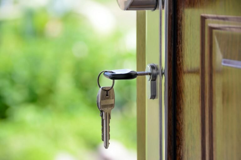 ‘It Is a Crisis’: Mayors Across the U.S. Say Housing Affordability Defines Their Tenure 2 Key inserted in door lock against a blurred green background, symbolizing security and real estate.