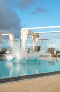 Ashton Hall diving into a pool