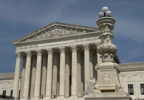 Two Executives Sentenced to 20 Years in $233 Million Affordable Care Act Fraud Scheme 7 a large building with columns and a clock on top of it