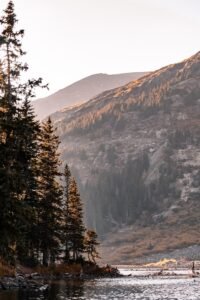 a group of people standing on the shore of a lake
