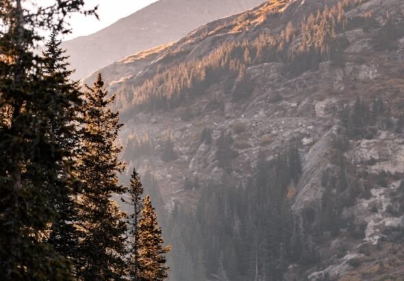 a group of people standing on the shore of a lake