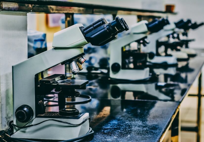 white microscope on top of black table