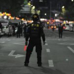 Police officers maintaining order during a night street patrol, ensuring public safety, crime, justice, drug, racketeering, violence, gang, arrest