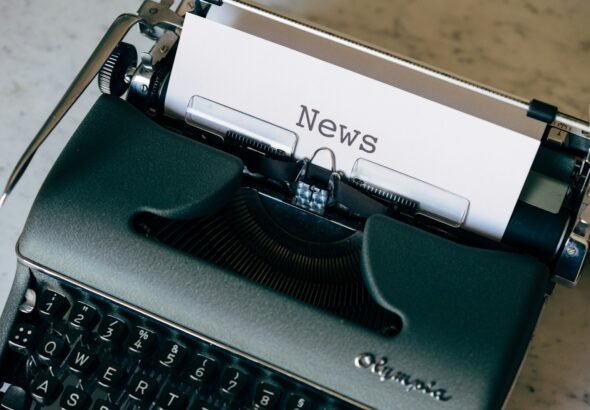 green and white typewriter on brown wooden table, news, crime, art, business, science, world, politics, environment, climate, fraud
