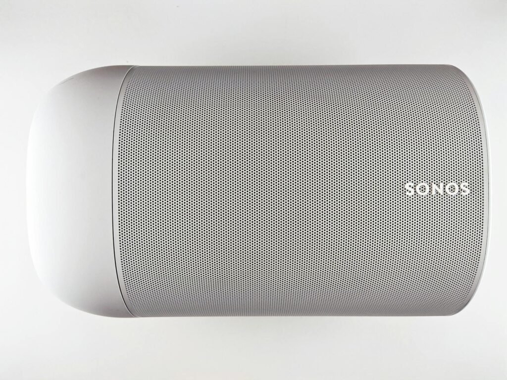 Sonos Users Push Back After App Update Breaks Speakers — Legal Action Underway 1 Top view of a sleek wireless speaker with a minimalistic design.