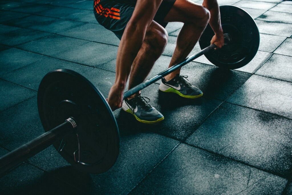 FTC Sues LA Fitness Over Difficult Gym Membership Cancellation Practices 1 person about to lift the barbel