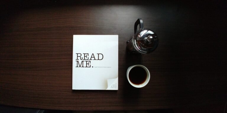 flat-lay photo of Read Me. book beside cup and silver mug on table. Press Release, guest post, sponsored posts, classified listing, ad, space, newsletter, press release, search page, forum, press release,