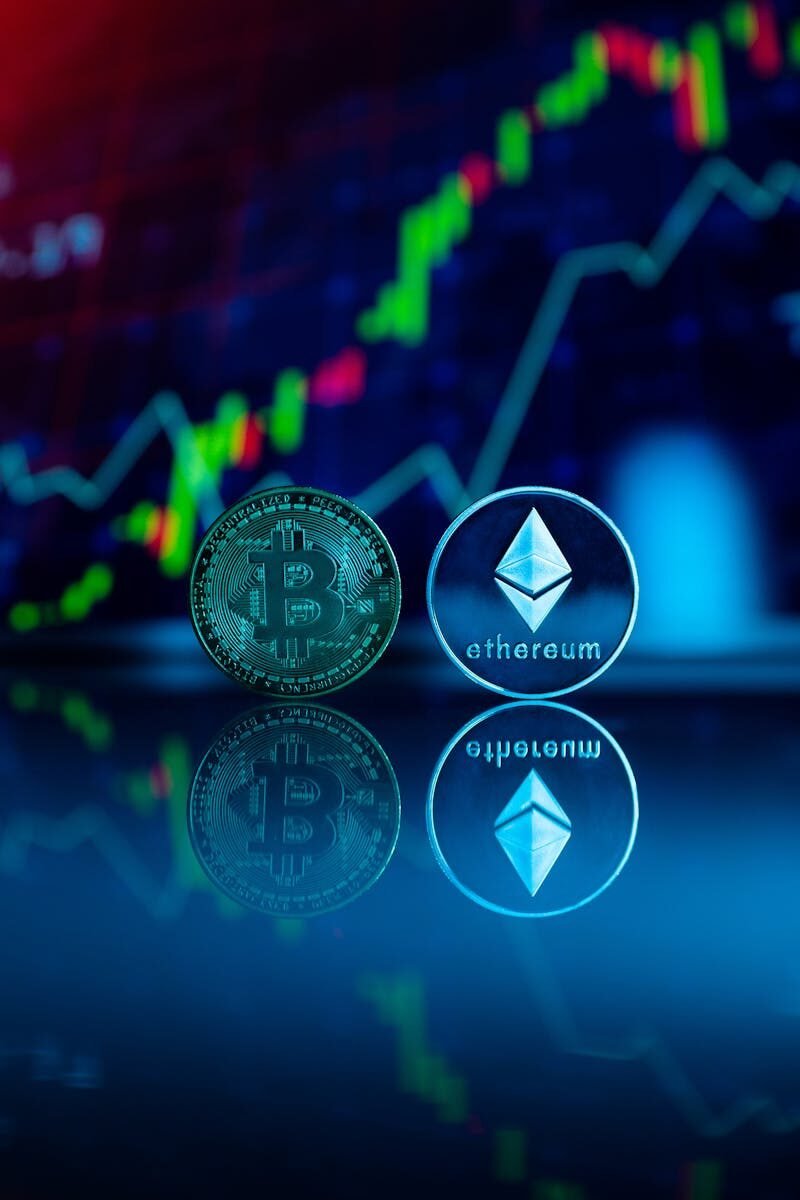 Conceptual image of Bitcoin and Ethereum coins reflecting stock market graph for cryptocurrency trading. crypto