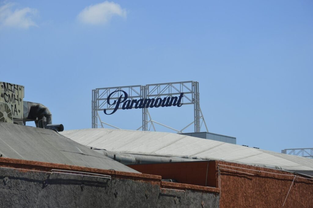 Paramount studios' sign stands against the blue sky.