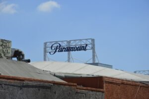 Paramount studios' sign stands against the blue sky.