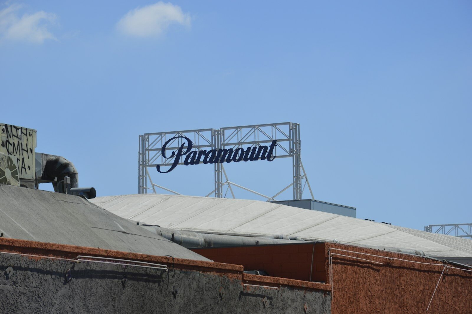 Paramount studios' sign stands against the blue sky.
