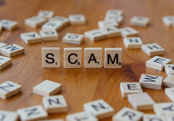 Three Schemes, Three Settlements: AG James Targets Travel, Tenants, and Crypto Investors 4 Scam spelled with scrabbles on a wooden table, schemes