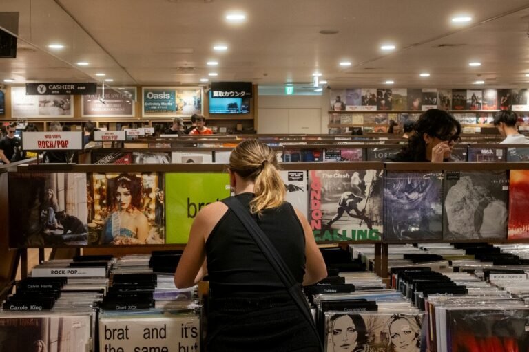 People browse vinyl records in a record store. charli xcx
