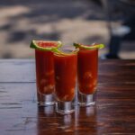 Three shot glasses filled with a bloody drink, Bloody Mary
