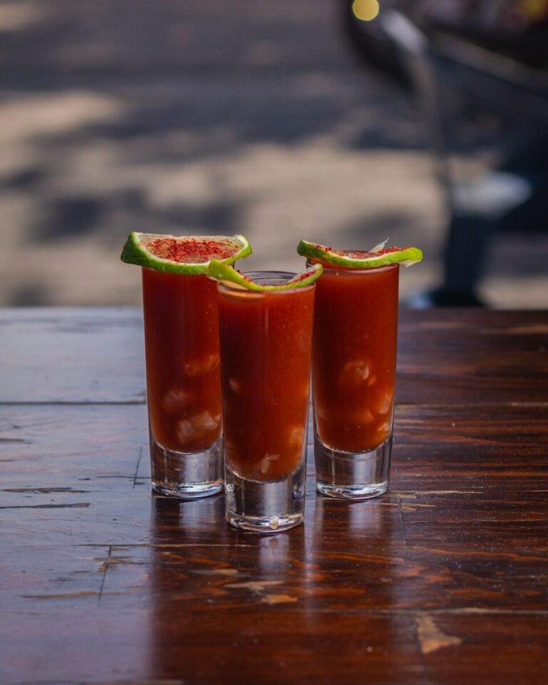 Three shot glasses filled with a bloody drink, Bloody Mary