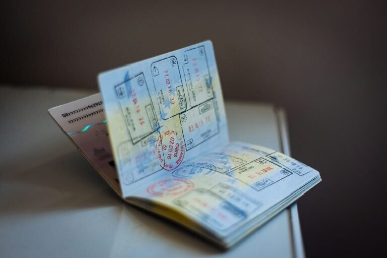 Five Charged in Alleged H-2A Visa Fraud and Alien Smuggling Ring That Seized Workers’ Passports, Demanded Kickbacks 3 An open passport with numerous ink stamps on the pages on a table, travel, visa